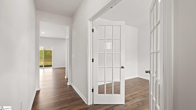 corridor featuring dark hardwood / wood-style flooring and french doors