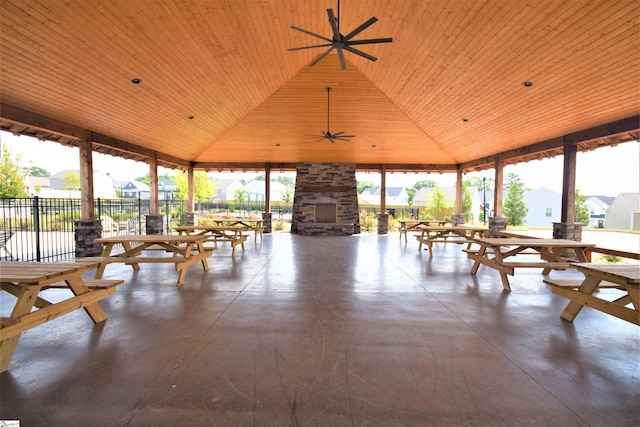 sunroom with ceiling fan, wood ceiling, and vaulted ceiling