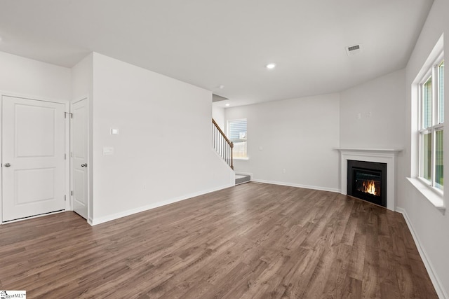 unfurnished living room with dark wood-type flooring