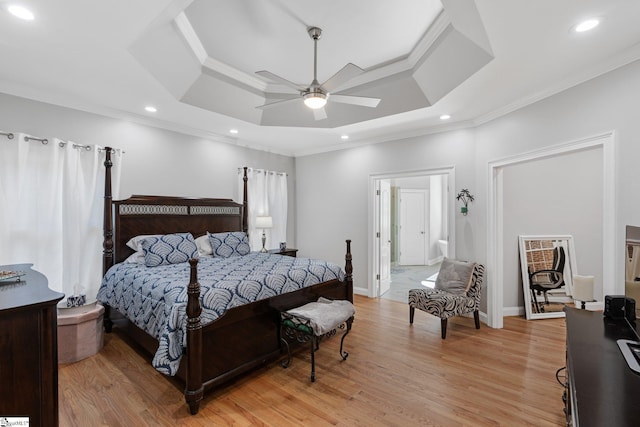 bedroom with a raised ceiling, ornamental molding, and light hardwood / wood-style flooring