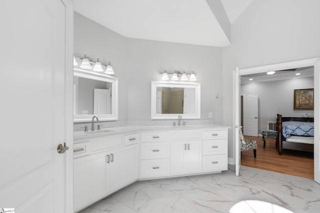 bathroom with vanity and lofted ceiling