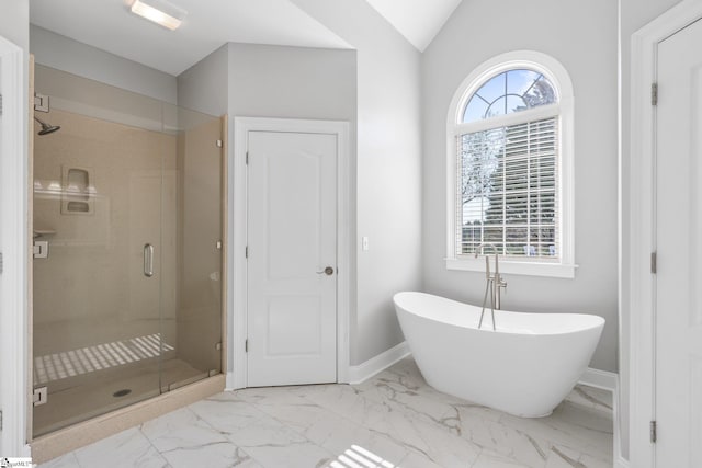 bathroom featuring lofted ceiling, plenty of natural light, and plus walk in shower