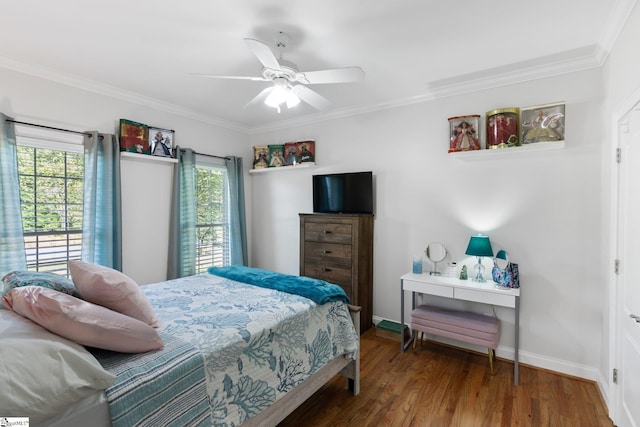 bedroom with hardwood / wood-style flooring, ornamental molding, and ceiling fan