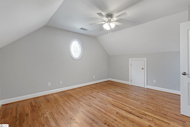 additional living space with vaulted ceiling, ceiling fan, and light hardwood / wood-style flooring