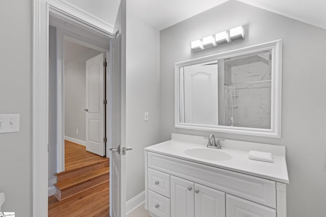 bathroom featuring vanity, wood-type flooring, and walk in shower