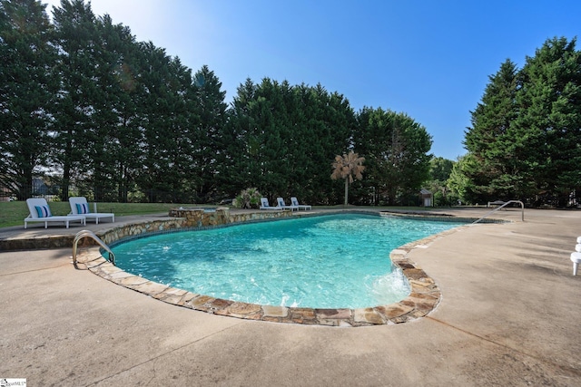 view of swimming pool with a patio area