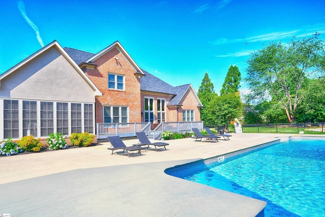 view of pool with a patio and a deck