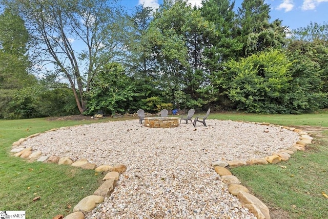 view of yard with a fire pit