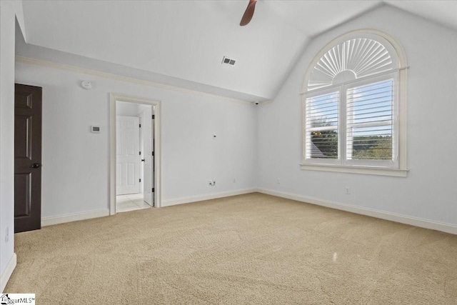 carpeted empty room featuring ceiling fan and lofted ceiling