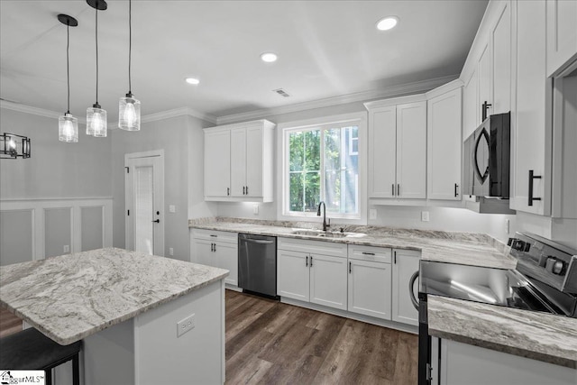 kitchen with pendant lighting, sink, white cabinetry, black appliances, and a kitchen island