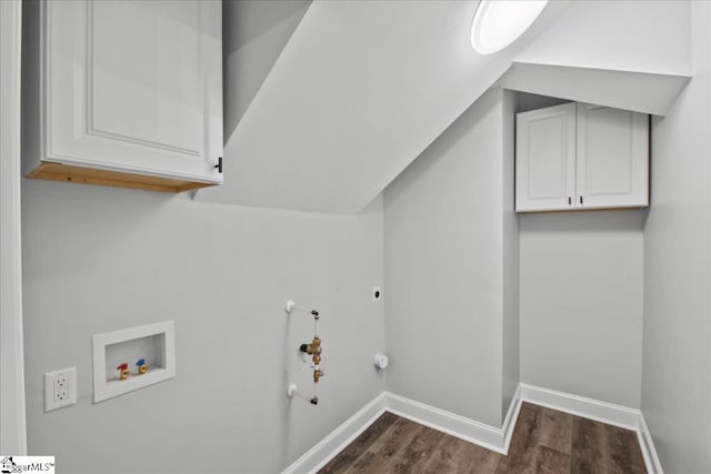 laundry area with gas dryer hookup, dark wood-type flooring, electric dryer hookup, hookup for a washing machine, and cabinets