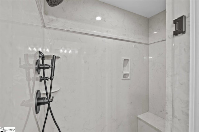 bathroom with tiled shower