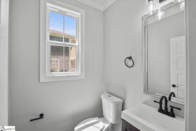 bathroom featuring crown molding, vanity, and toilet