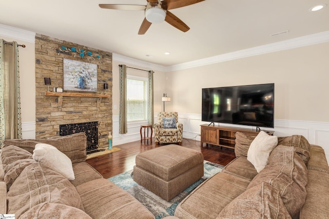 living room with ceiling fan, a fireplace, dark wood-type flooring, and ornamental molding