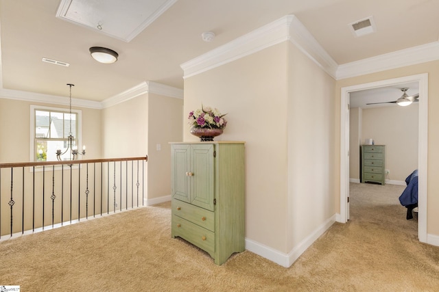 corridor featuring ornamental molding, light carpet, and an inviting chandelier