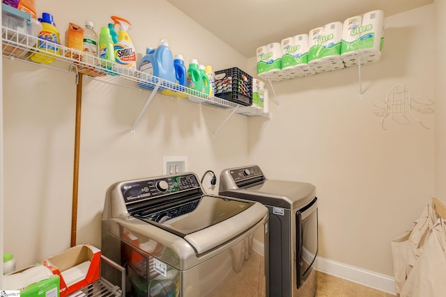 laundry room with light tile patterned floors and separate washer and dryer