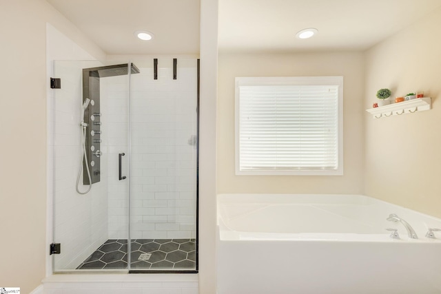 bathroom featuring independent shower and bath