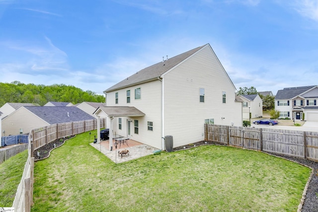 back of house featuring a yard and a patio