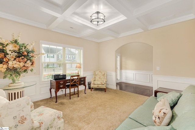 interior space featuring a chandelier, beam ceiling, ornamental molding, and coffered ceiling