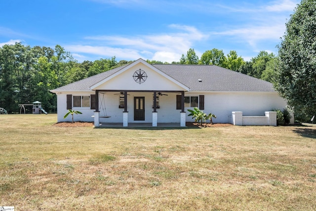 single story home featuring a front yard, a playground, and ceiling fan