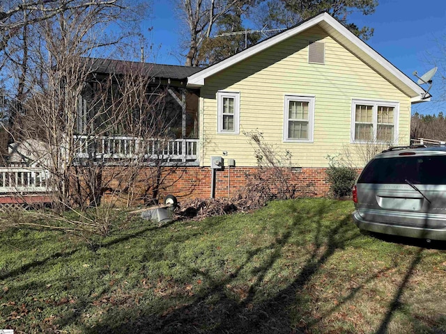 view of side of property with a yard