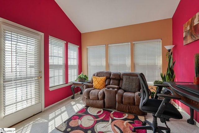 carpeted home office with vaulted ceiling