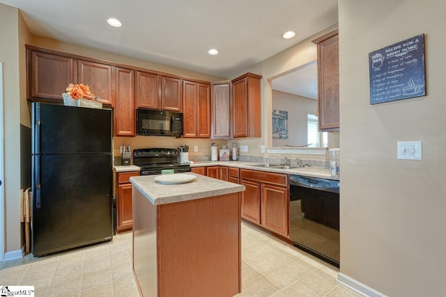 kitchen with sink, a kitchen island, and black appliances