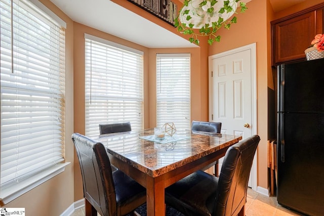 dining space featuring light tile patterned floors