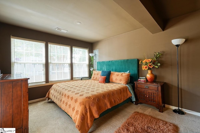 carpeted bedroom featuring multiple windows