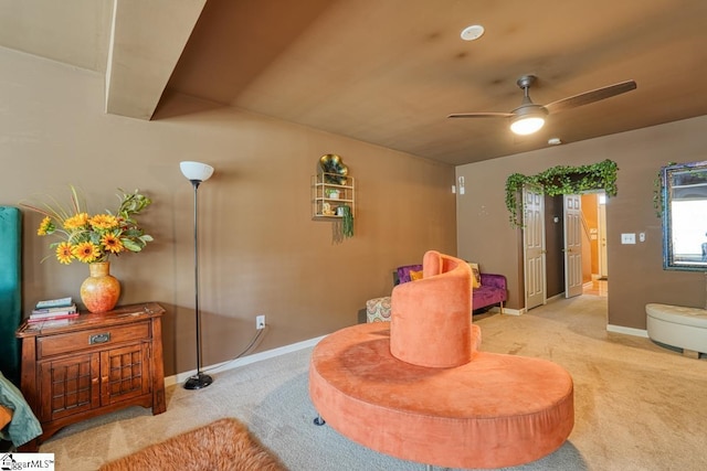 interior space featuring light colored carpet and ceiling fan