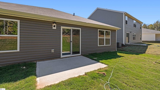 back of property featuring a patio area, a yard, and central AC unit