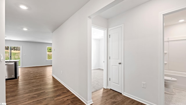 hall with dark hardwood / wood-style floors