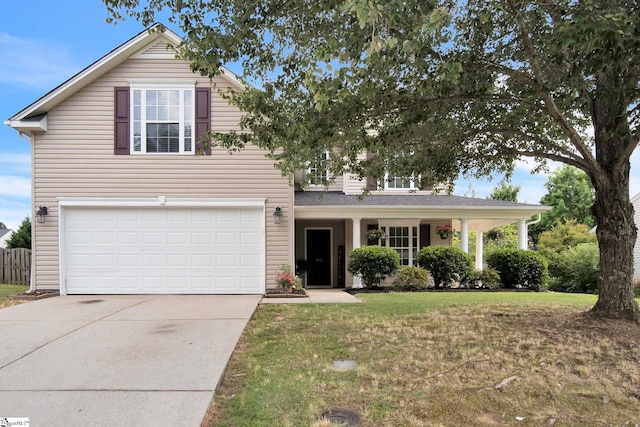 front facade featuring a front yard and a garage