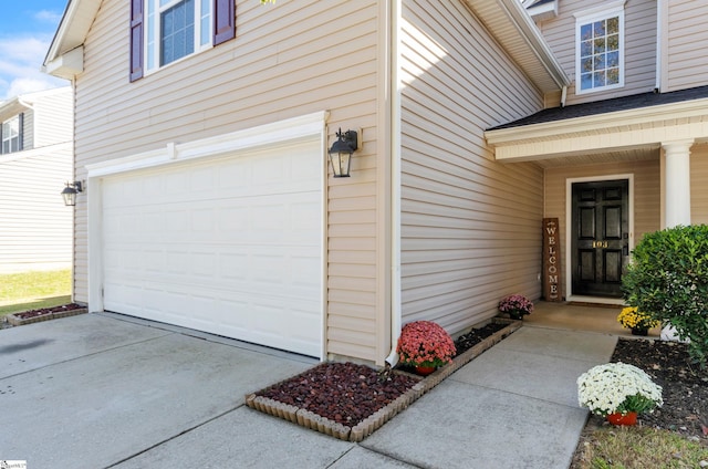 doorway to property with a garage