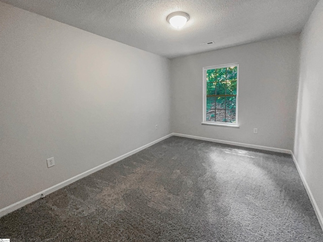 spare room with a textured ceiling