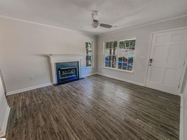 unfurnished living room with a textured ceiling, ceiling fan, dark hardwood / wood-style floors, and ornamental molding