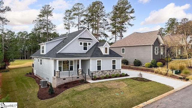 view of front of property featuring a front lawn, central AC unit, and a porch