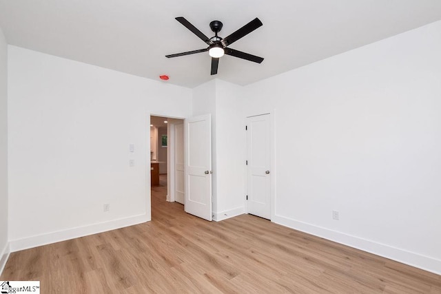 empty room featuring ceiling fan and light hardwood / wood-style flooring