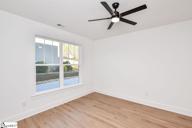 empty room with ceiling fan and light hardwood / wood-style flooring