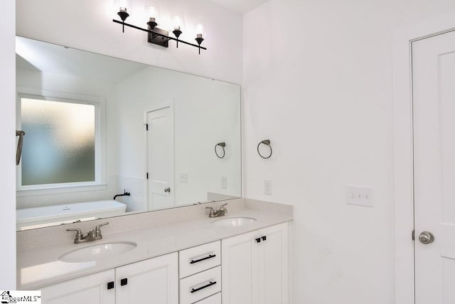 bathroom with a bath and vanity