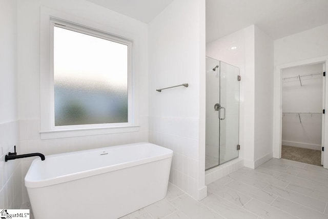 bathroom featuring plus walk in shower