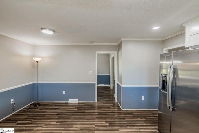 unfurnished room with a textured ceiling, dark wood-type flooring, and ornamental molding