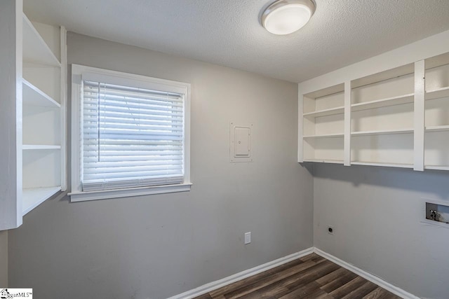 clothes washing area featuring a wealth of natural light, hookup for a washing machine, dark hardwood / wood-style floors, and a textured ceiling