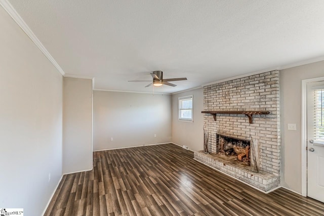 unfurnished living room with ceiling fan, dark hardwood / wood-style floors, a textured ceiling, a fireplace, and ornamental molding