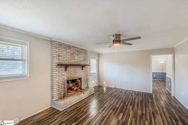 unfurnished living room with a textured ceiling, a fireplace, and plenty of natural light