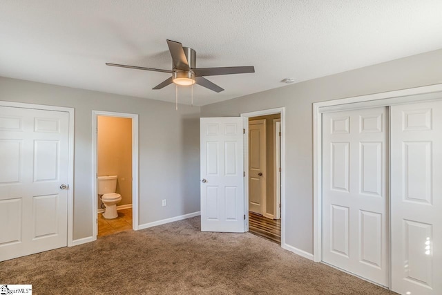 unfurnished bedroom with ceiling fan, light colored carpet, connected bathroom, and a closet