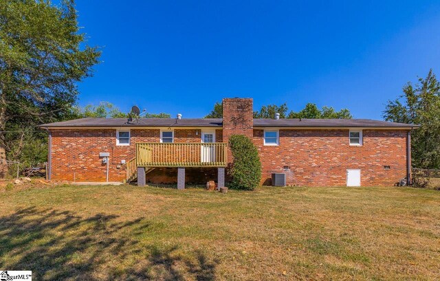 back of house featuring central AC, a yard, and a deck