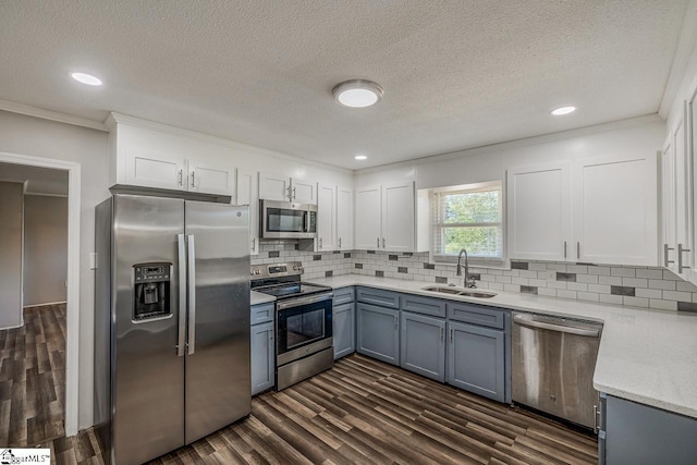 kitchen featuring white cabinets, crown molding, sink, and stainless steel appliances