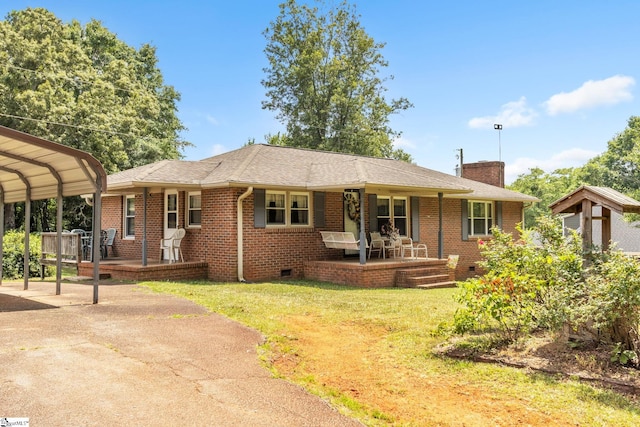 ranch-style house with a carport, a porch, and a front lawn