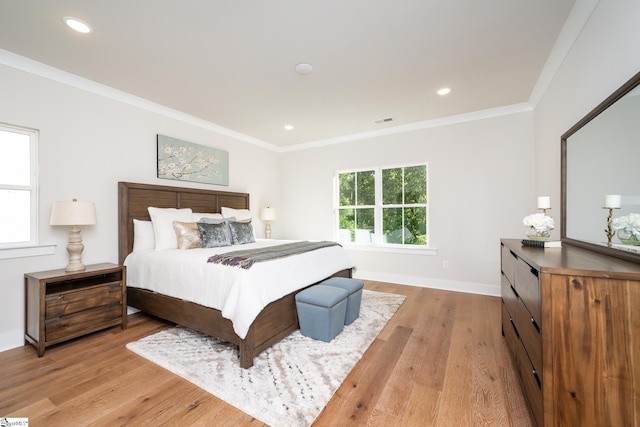 bedroom with light hardwood / wood-style floors and ornamental molding